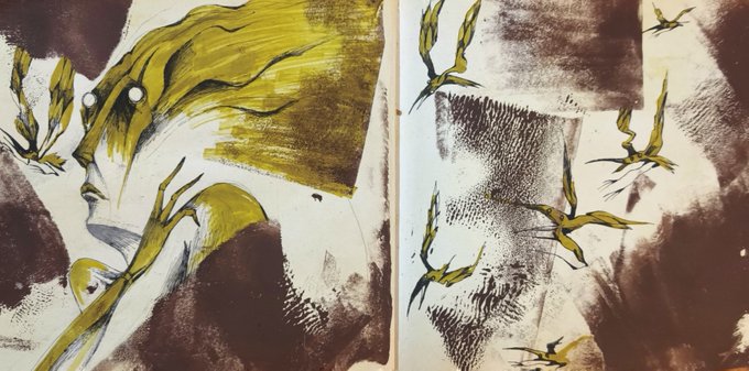 An abstract mixed-media artwork in a sketchbook featuring expressive brushstrokes in yellow, brown, and black with bird-like figures.