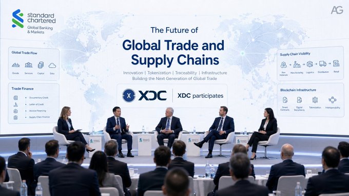 A panel discussion at an event titled 'The Future of Global Trade and Supply Chains,' hosted by Standard Chartered Global Banking & Markets and XDC participates, featuring speakers seated on stage discussing topics like Global Trade Flow, Trade Finance, Supply Chain Visibility, and Blockchain Infrastructure.