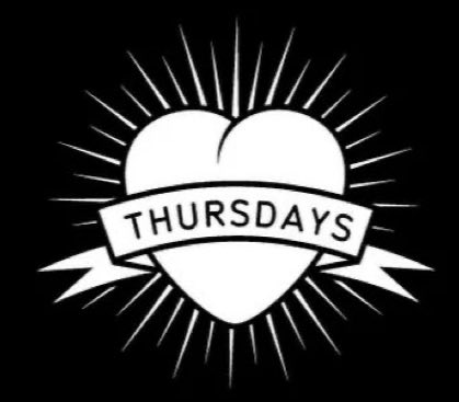 A white heart with radiating lines has a banner across it that reads "THURS DAYS". This image relates to the post by symbolizing tomorrow, Thursday, as the potential day for "Clarity" to drop and impact XRP liquidity.