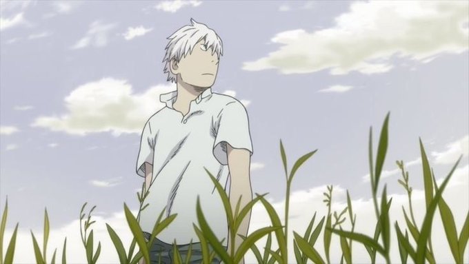 A young man with white hair and a white polo shirt stands in a tall grass field, gazing into the distance under a partly cloudy sky, capturing a serene, reflective moment that complements the cheerful weekend greeting.