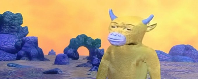 A CGI yellow creature with blue horns and a purple snout stands in a surreal landscape with blue rock formations and an orange sky.
