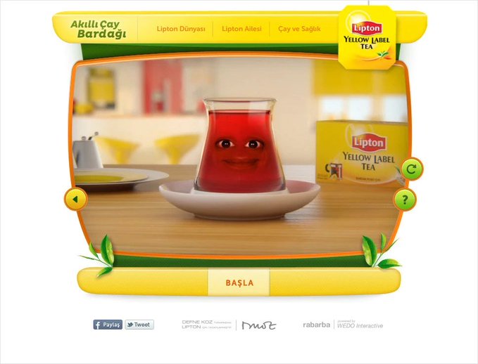 A Lipton Yellow Label Tea Turkish website interface ('Akıllı Çay Bardagi' / Smart Tea Cup) featuring an animated 3D glass of tea with a smiling face, with a 'BAŞLA' (Start) button.