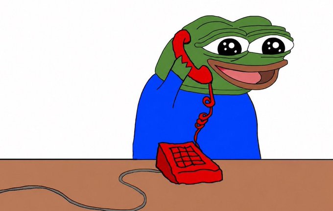 A cartoon drawing depicts the 'Pepe the Frog' meme character smiling while holding the receiver of a red landline telephone.