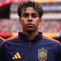A young soccer player wearing a red and navy jersey with an Adidas logo appears focused before a match, with the post's caption about earning $1M suggesting this could be a star rising player whose success feels inevitable.