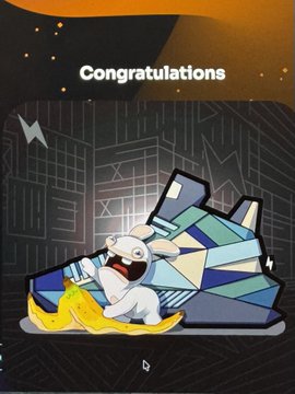 The image features a cartoon banana character sitting on top of a blue and white geometric-patterned shoe, with the text "Congratulations" written above it. The scene also includes a lightning bolt and a city skyline backdrop, creating an urban atmosphere.