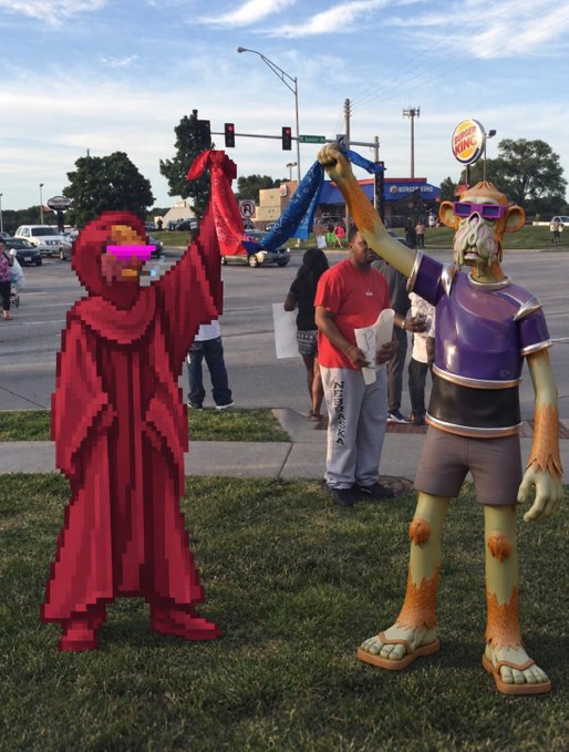 A surreal outdoor scene featuring a pixelated red-robed figure and a monkey-like humanoid statue standing on grass, with real people visible in the background near a Burger King.
