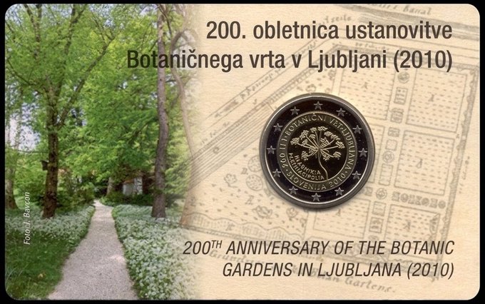 A commemorative 2 Euro coin celebrating the 200th anniversary of the Botanic Gardens in Ljubljana (2010), shown alongside a pathway through the gardens.