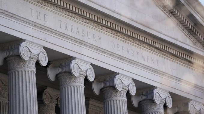 The neoclassical facade of the U.S. Treasury Department building stands with its iconic Ionic columns and engraved "THE TREASURY DEPARTMENT" inscription, visually anchoring the post's discussion of surging 30-year Treasury yields and the department's expanded $4 billion bond buyback program amid shifting monetary policy.