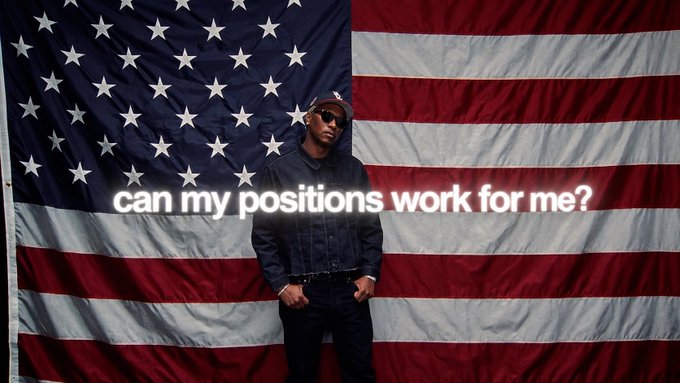 A man in sunglasses and a denim jacket standing in front of a large American flag backdrop with the text 'can my positions work for me?' overlaid across the image.