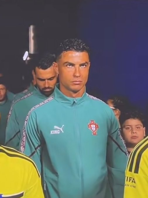Cristiano Ronaldo stands focused in a teal Puma training jacket featuring the Portuguese Football Federation crest and "KING" text on the chest, accompanied by teammates during what appears to be a pre-match walkout. His intense, determined gaze perfectly matches the "Gm Lock in" caption, conveying the mindset of complete focus and readiness before a big game.