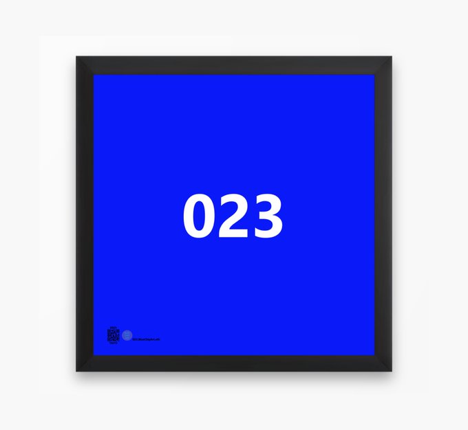 A blue framed poster displays the number "023" in white text in the center, with a small logo in the bottom left corner.