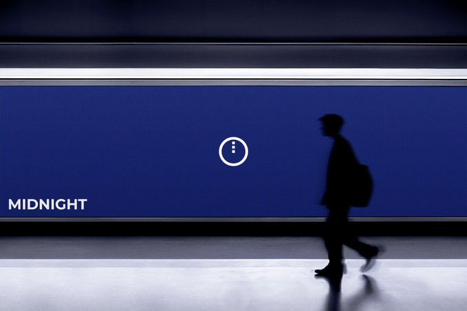 The image shows a man walking down an empty hallway or subway platform at night with a blue wall featuring a clock displaying "Midnight". The scene captures the silhouette of the person, emphasizing their solitary presence as they move through the space. The caption above the photo suggests that there is more to this particular post than meets the eye and encourages viewers to look beyond the surface-level content for deeper insights into what the image represents or implies.

The blue wall with a clock serves as an interesting visual element, drawing attention to the passage of time in the context of nighttime. The man's silhouette adds a sense of mystery and intrigue to the scene, inviting viewers to contemplate the story behind this particular image.