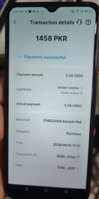 A smartphone screen shows a successful transaction of 1458 PKR (5.34 USDC) paid to merchant CHEEZIOUS Karachi PAK on 2026/08/10 at 17:37.