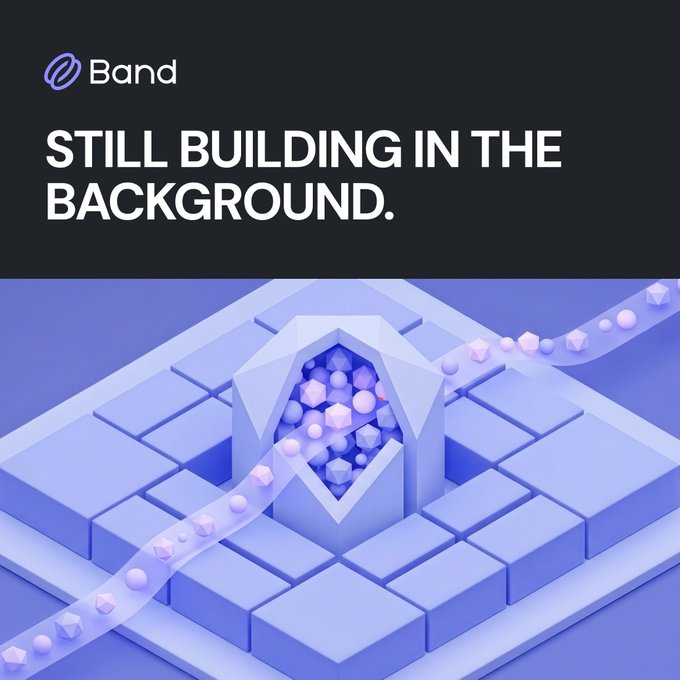 A dark graphic with the 'Band' logo features the text 'STILL BUILDING IN THE BACKGROUND' above a purple 3D illustration of cubes and geometric shapes.