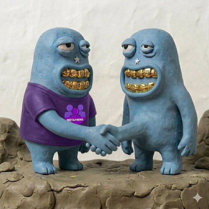 Two claymation-style blue monster figures shake hands, with the left one wearing a purple shirt displaying the "METAFRENS" logo—visually representing the announced collaboration between Metafrens and t00ns.