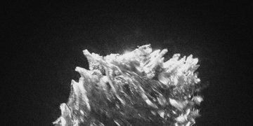The image shows a striking black-and-white close-up of what appears to be crystalline or mineral formations, with sharp, spiky textures emerging against a dark background, resembling a cluster of raw quartz or ice crystals. The abstract, otherworldly visual aligns with the mysterious and enigmatic tone of the "incognita" NFT mint, evoking an unknown or hidden natural phenomenon being revealed through the digital artwork.