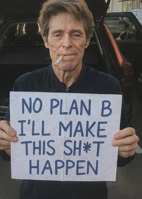 An older man with weathered features smoking a cigarette while holding a handwritten sign that reads 'NO PLAN B I'LL MAKE THIS SH*T HAPPEN', standing in front of a dark SUV.