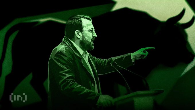 A man in a suit speaks passionately at a podium, pointing to his right, with a stylized green-toned bull silhouette looming behind him, visually reinforcing the post's playful jab about his intense devotion to Ripple, XRPL, and the XRP community. The BeInCrypto logo appears in the lower left corner.