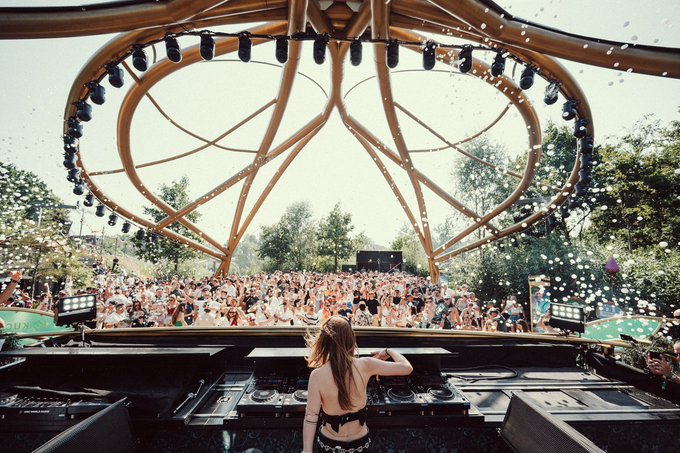 A DJ performs on The Celestia Stage by KuCoin to a large crowd enjoying a festival. The image captures the energetic atmosphere of the event, aligning with the provided social media post.