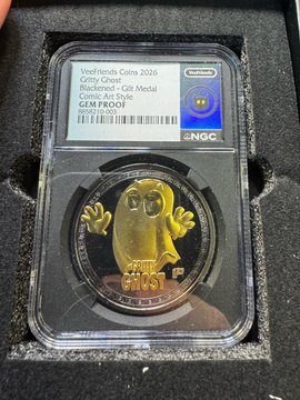 A close-up photograph of a 2026 Vootfriends Coins gold coin featuring an owl design, encapsulated in an NGC slab with a 'Blackened' finish grade label.