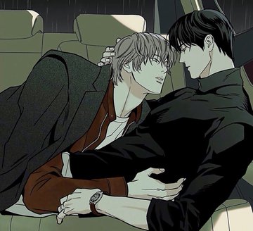 An illustrated scene of two men with dark hair embracing intimately on a couch, one wearing a dark coat over a brown jacket while the other wears all black.
