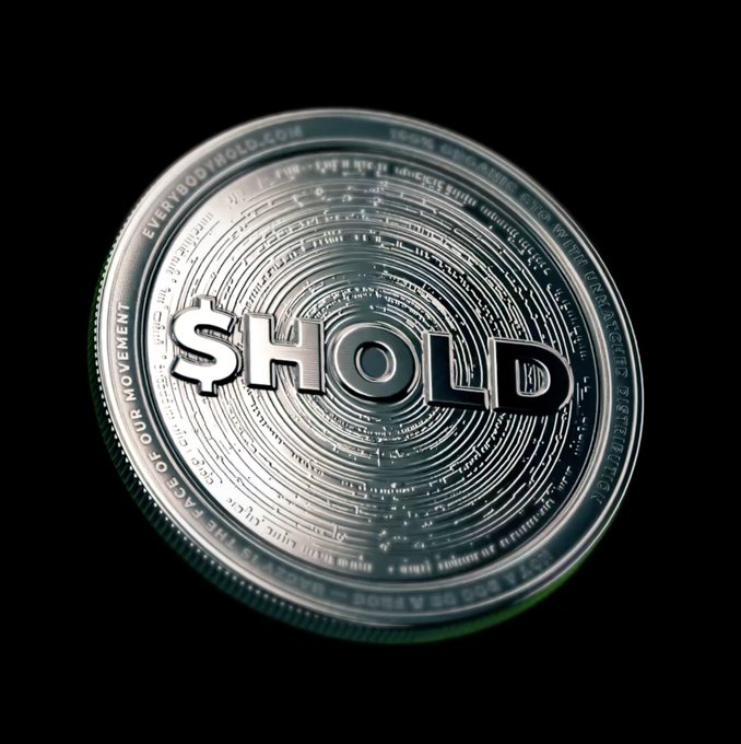 A close-up 3D rendering of a silver coin against a black background, engraved with the word '$HOLD' in the center and surrounded by intricate circular patterns and text.