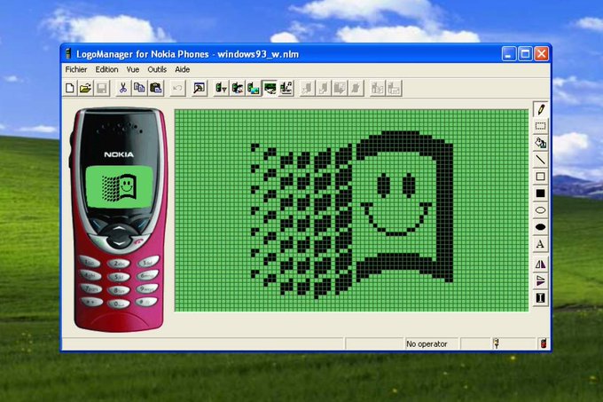 A vintage Windows 93 era LogoManager application for Nokia phones displaying a pixelated smiley face design being edited on a green grid.