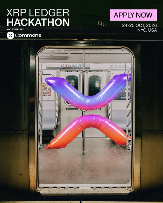 The image promotes the **XRP Ledger Hackathon**, hosted by **Commons**, taking place **October 24–25, 2026 in NYC, USA**, with an "APPLY NOW" call-to-action. The background features a vibrant purple-to-orange gradient **XRP logo** (an X-shaped design made of glossy, dimensional shapes) displayed inside a subway car, symbolizing the movement of money and digital assets through transit-like infrastructure, aligning with the event's theme of building AI-driven payment and financial tools onchain.
