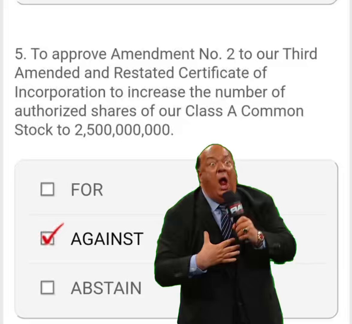 The image features a man wearing a suit, standing next to a microphone with his mouth open as if he's speaking into it. There are several buttons visible around him, including one that says "FOR" and another that says "AGAINST". The text in the image is related to an online poll or discussion about the man's stance on certain issues.