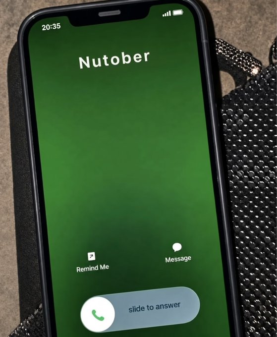 A smartphone displaying an incoming call screen with the caller name 'Nutober' against a green gradient background, showing a time of 20:35 and standard call answer options including 'Remind Me' and 'Message'.