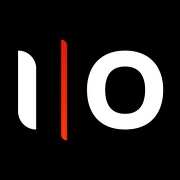 The image features a stylized white logo on a black background that appears to represent "IO" — with the "I" formed by a vertical white bar beside a red vertical line, and a circular "O." This likely serves as the IO Labs logo, relevant to the news about Cardano's Plutus engineering team transitioning from IO Labs (IOG) to Midgard Labs.