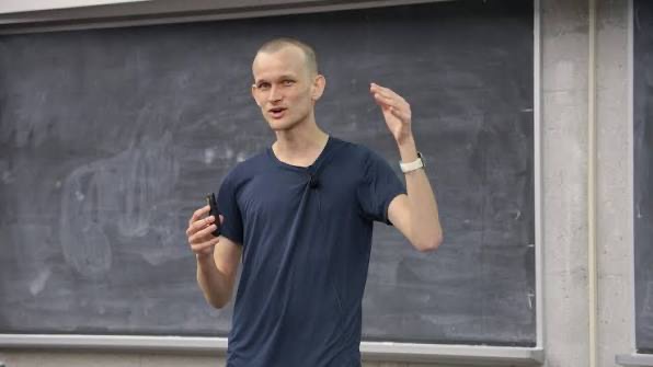 The image shows Vitalik Buterin, Ethereum's co-founder, standing in front of a chalkboard while speaking and gesturing with a clicker in hand. This visually connects to the post about his new "Lean Ethereum" roadmap, as he is the architect behind this ambitious multi-year upgrade plan featuring STARKs, quantum-resistant security, and cheaper transactions.