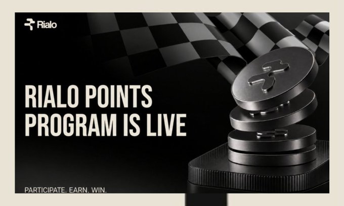 A promotional banner for 'Rialo' announcing 'RIALO POINTS PROGRAM IS LIVE' with the tagline 'PARTICIPATE. EARN. WIN.' next to an image of stacked metallic coins with an 'R' emblem and a checkered flag.