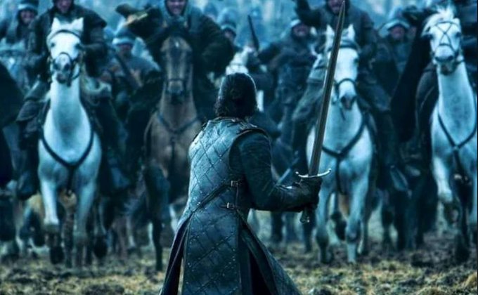 A lone warrior in dark quilted armor readies his sword as a massive cavalry of mounted soldiers charges toward him across a foggy battlefield. The image evokes the post's metaphor of standing firm against an overwhelming market downturn, capturing the battle cry to "Take. It. Easy." and hold steady through the overnight decline in ETH and BTC, knowing higher prices lie beyond the doubt.