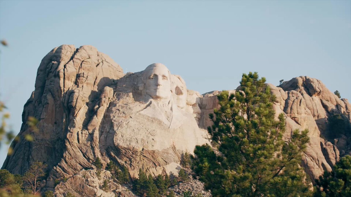 The image features a large rock formation with a statue of George Washington carved into its surface, which appears to be the main focus of the photo. The background includes trees and other natural elements that complement the overall scene. The caption provided seems to be related to a discussion about the statue or the post itself, but it is not clear what specific content is being referred to in the caption.