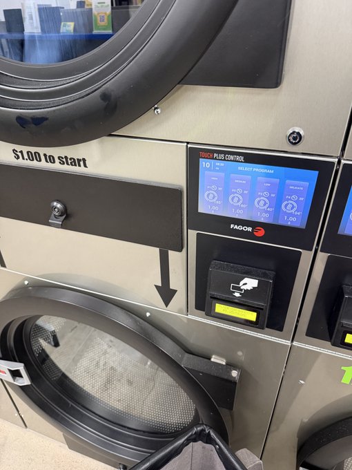A close-up photo of a Fagor commercial laundry machine control panel with a touchscreen displaying 'RESET PROGRAM' and payment options at $1.00.