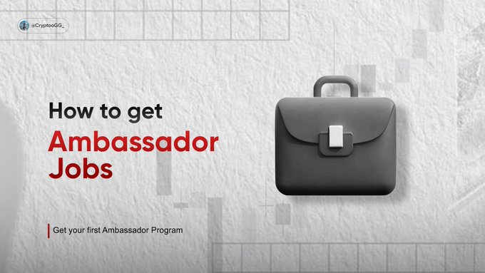 A promotional graphic with a gray briefcase icon titled 'How to get Ambassador Jobs' with the subtitle 'Get your first Ambassador Program' and the handle @CryptoOG_ in the top left corner.