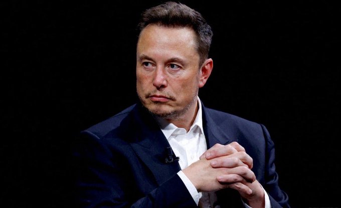 The image features a man dressed in a suit, standing against a black background with his hands clasped together. He appears to be looking off into the distance or deep in thought. The caption of the image reads "Treasury to The Banks" followed by "via XRP banks to your Wallets via XLM". This suggests that the man might be discussing financial matters related to the Treasury Department and the Federal Reserve Bank, which are known for their involvement with cryptocurrencies like Bitcoin.