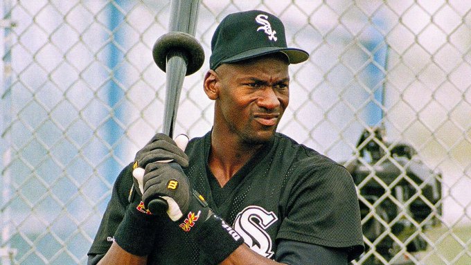 A Black baseball player in a black Chicago White Sox jersey and cap (with the "Sox" logo) holds a bat over his shoulder behind a chain-link fence, glancing to the side with a skeptical expression. The caption wryly uses his look of doubt or judgment to humorously second-guess a friend's "Cobie" for taking a job at Coinbase.