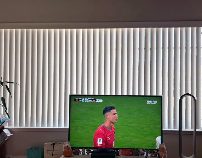 A TV displays a soccer match on ESPN featuring Portugal's Cristiano Ronaldo, with the scoreboard showing a 0-0 draw between Portugal and Slovenia at the 92:32 mark. The image reflects the post's commentary on a tedious 90-minute game that eliminated Ronaldo, while crypto charts visible at the bottom of the screen mirror the "dead loop" sentiment about stagnant SOL and BSC market trends.
