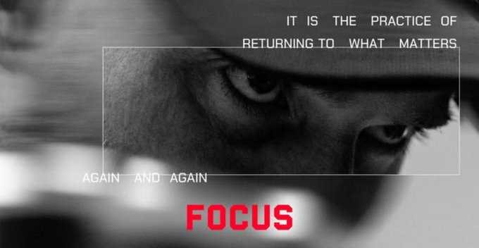 A motivational poster featuring a close-up of a person's intense eyes in black and white with the text 'IT IS THE PRACTICE OF RETURNING TO WHAT MATTERS AGAIN AND AGAIN' and 'FOCUS' in red.