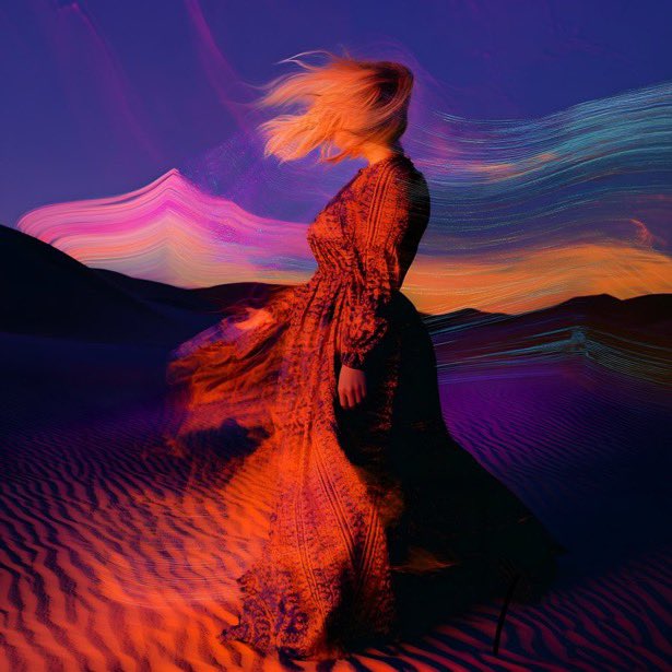 A surreal image of a blonde woman in a flowing red dress standing on textured sand dunes, with flowing pink, purple, and blue streams of color filling the sky behind her.
