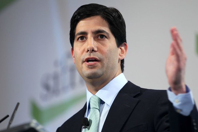 The image features a man wearing a suit and tie standing at a podium with his hand raised. The background of the image shows a green sign that reads "SILVER". The caption below the image reads, "KEVIN WARSH: 'If you're under 40, Bitcoin is your new gold'. Focus on what is in the image and how it relates to the post."