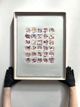 A pair of hands wearing black gloves holds up a framed grid of 25 small colorful sugar skull illustrations, displayed against a gray background. The artwork appears to be a limited-edition archival print, fitting with the social media post highlighting its rarity and availability.