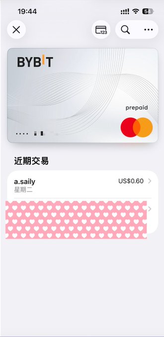 In the image, there's a credit card application open on an iPhone screen with the app named "Bybit" displayed at the top left corner of the screen. The main focus of the scene is the user applying for a U Card or U Visa, which is essential for making payments to people from other countries, especially in Asia. Bybit has stated that their U Card can handle 99% of scenarios, providing it as an option for users looking to make international transactions. This card link appears to be free, making it an appealing choice for those who need access to a worldwide payment network without incurring any costs or restrictions.