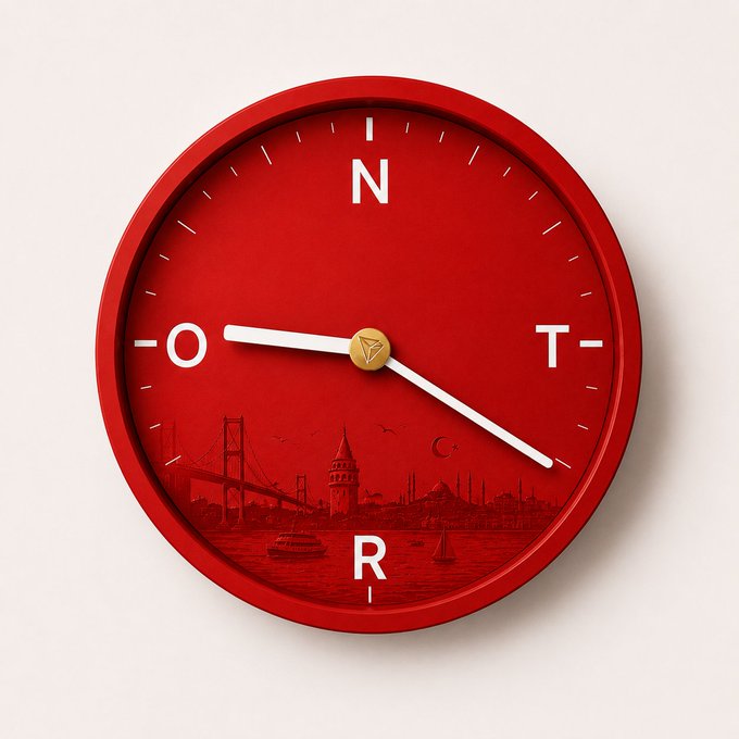 The image features a red clock with white numbers and hands, set against a white background. The clock has a unique design that includes a picture of a bridge and boats sailing across the water. Below the clock, there's text that reads "Her saniye yeni bir fırsat. Her adımda daha güçlü bir ekosistem #TRON ile geleceğin dijital altyapısı şekilleniyor." This phrase is related to the post, which seems to be about a travel destination or an interesting location.