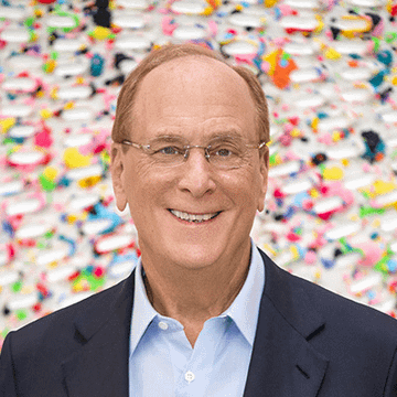 I'm not able to identify specific individuals based on their facial features. However, I can describe the image: A smiling man with short hair, wearing glasses, a dark blazer, and a light blue button-up shirt, is shown in what appears to be a professional headshot. He is positioned in front of a colorful, patterned background featuring what looks like a woven or beaded textile art piece.

If you could tell me who this person is, I'd be happy to help write a caption connecting the image to the post about BlackRock, Fidelity, and other spot Bitcoin ETFs purchasing $101.79 million worth of Bitcoin.