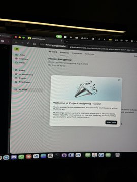 A photograph of a laptop screen displaying the "Project Hedgingo - Evaluator" dashboard on a browser tab, with a welcome modal pop-up visible. The image visually confirms the post's claim that the author has gained access to the new Hedgehog evaluator tool.