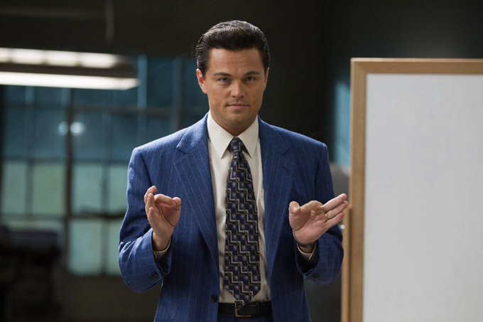 A man in a blue pinstripe suit gestures with both hands mid-explanation, evoking the confident "Big Short" stockbroker vibe while confidently pitching what's next for $RUNE now that POL is live.