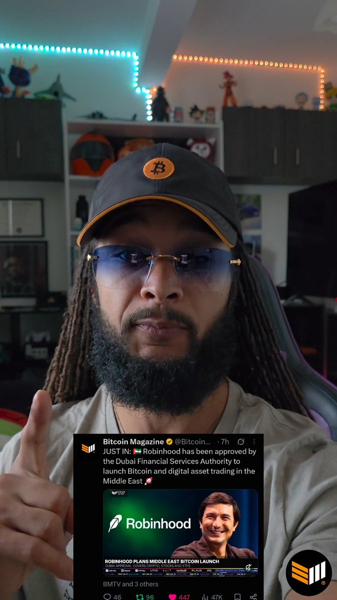 A man in a Bitcoin cap and glasses raises one finger in a home office. An embedded Bitcoin Magazine post says: “JUST IN: 🇵🇸 Robinhood has been approved by the Dubai Financial Services Authority to launch Bitcoin and digital asset trading in the Middle East. 🚀”